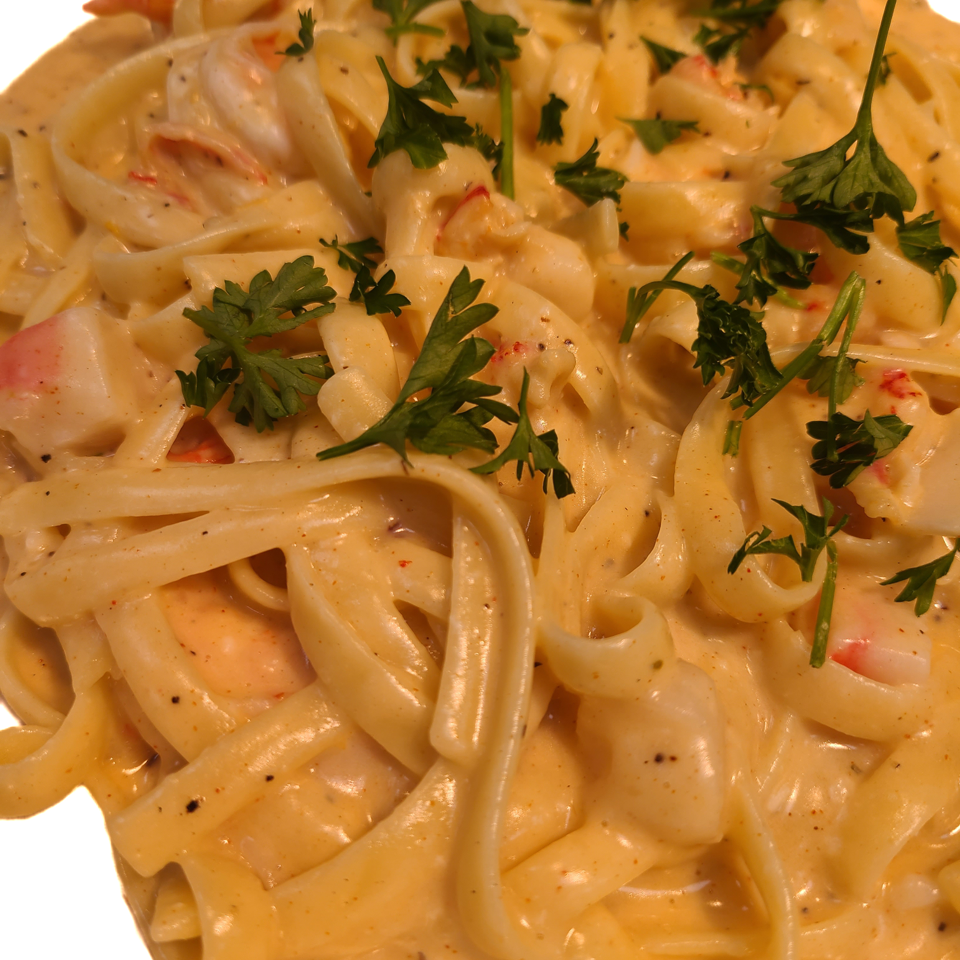 Creamy pasta topped with parsley.