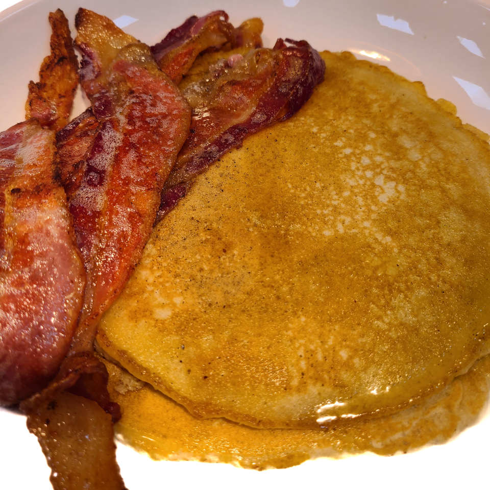Pancakes served with bacon.