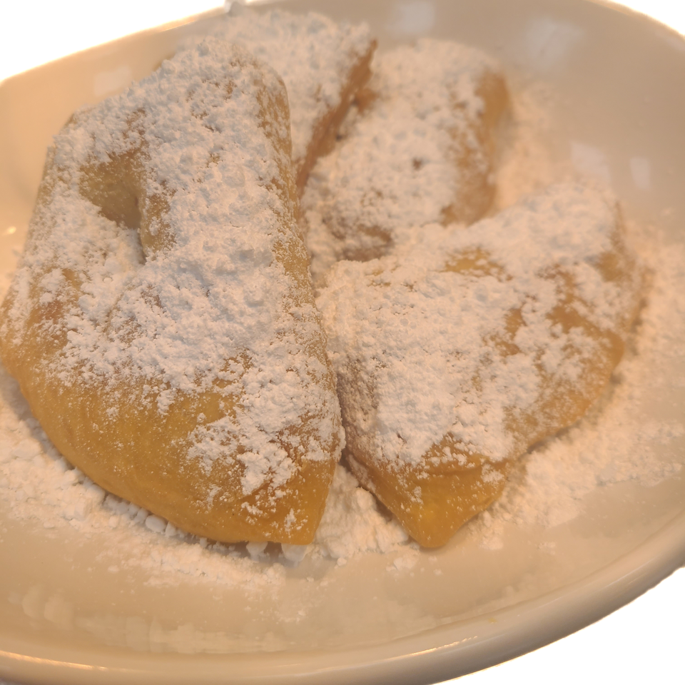 Beignets dusted with powdered sugar.