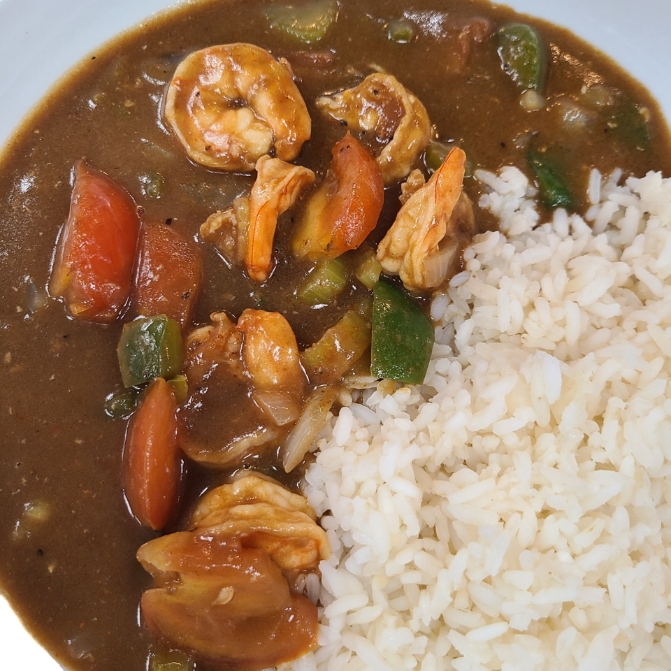 Shrimp and vegetables in brown sauce served with white rice.